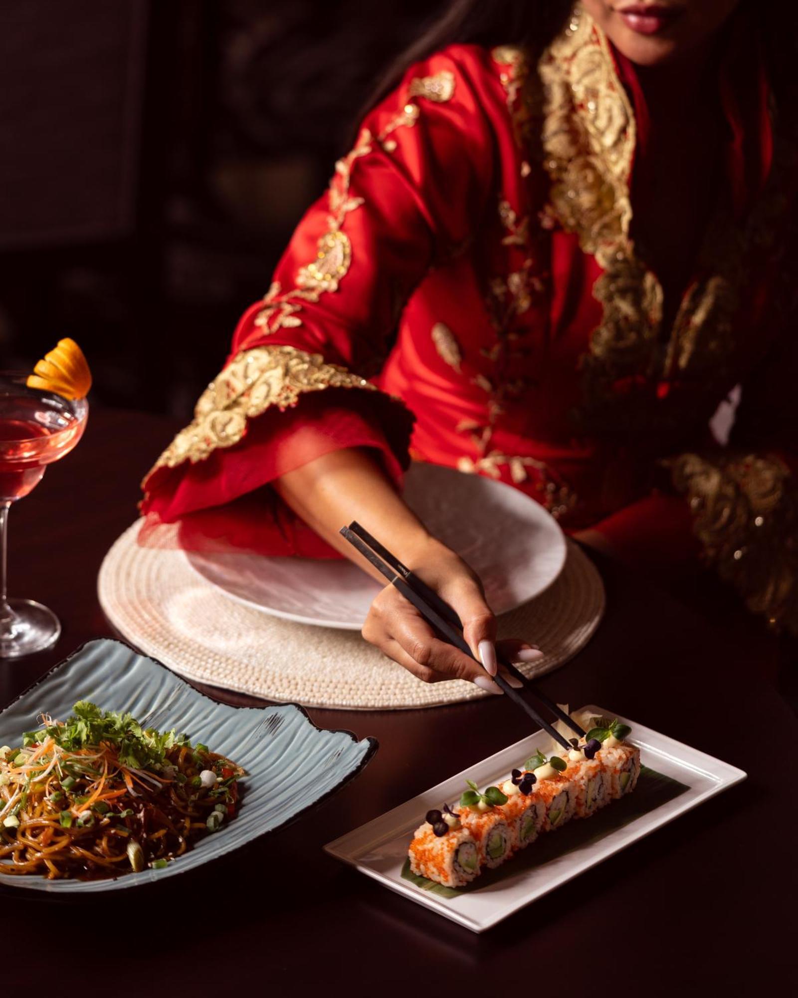 City Centre Rotana Ad-Dauha Zewnętrze zdjęcie A woman using chopsticks